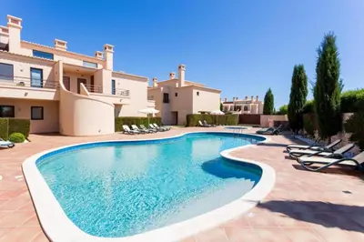 a swimming pool in front of a villa at Mar da Luz in Luz