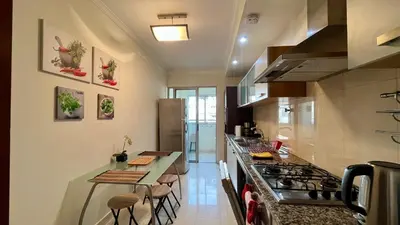 a kitchen with a stove and a counter with stools at Madeira Emotions Apartments in Funchal