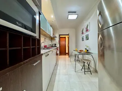 a kitchen with a stainless steel refrigerator and a table at Madeira Emotions Apartments in Funchal