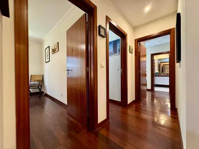 a hallway with two doors and a wooden floor at Madeira Emotions Apartments in Funchal