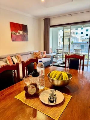 a dining room table with a bowl of bananas on it at Madeira Emotions Apartments in Funchal