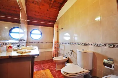 a bathroom with a toilet and a sink at Casa da Rocha in Calheta
