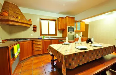 a kitchen with a table with a table cloth on it at Casa da Rocha in Calheta