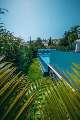 a swimming pool on the side of a house at Casa Maravilha in Caniço