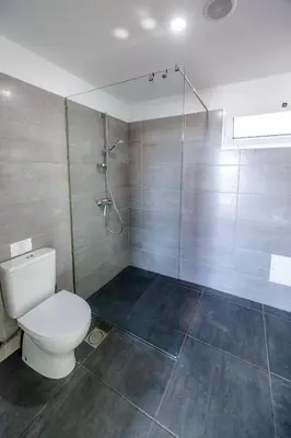 a bathroom with a toilet and a shower at Casa Maravilha in Caniço