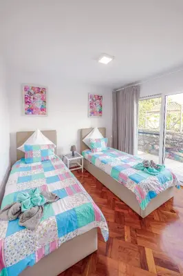 two beds sitting next to each other in a bedroom at Casa Maravilha in Caniço