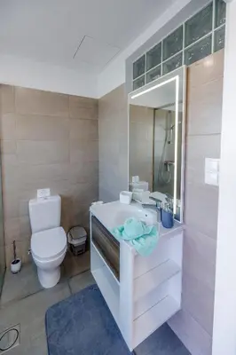a bathroom with a toilet and a sink and a mirror at Casa Maravilha in Caniço