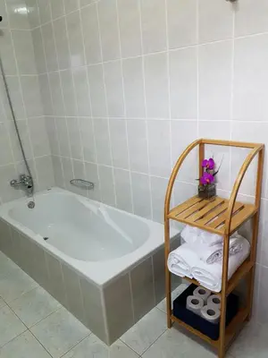 a bathroom with a tub and a shelf with towels at Apartment with beautiful ocean and city view in Funchal