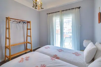 two beds in a room with a window and a ladder at Endemic - Concept Apartment in Funchal