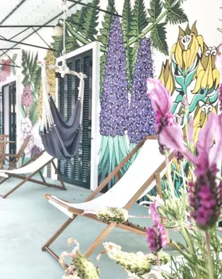 a room with two hammocks and a mural of flowers at Endemic - Concept Apartment in Funchal