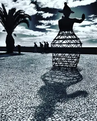 a shadow of a statue of a man with a hat at Endemic - Concept Apartment in Funchal
