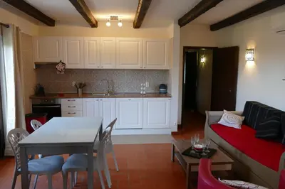a kitchen and living room with a table and a couch at Quinta Falzina in Luz