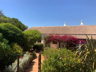 a garden in front of a house with flowers at Quinta Falzina in Luz