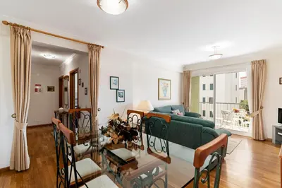 a living room with a green couch and a table at Ilhéus III by An Island Apart in Funchal