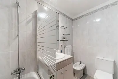 a bathroom with a shower and a toilet and a sink at Ilhéus III by An Island Apart in Funchal