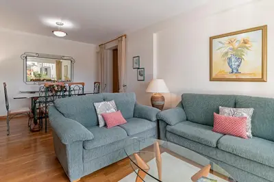 a living room with two blue couches and a table at Ilhéus III by An Island Apart in Funchal