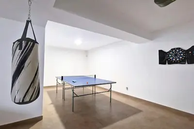 a ping pong table in a room with a painting on the wall at Villa Ravenala - by LovelyStay in Funchal