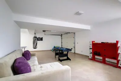 a living room with a couch and a ping pong table at Villa Ravenala - by LovelyStay in Funchal