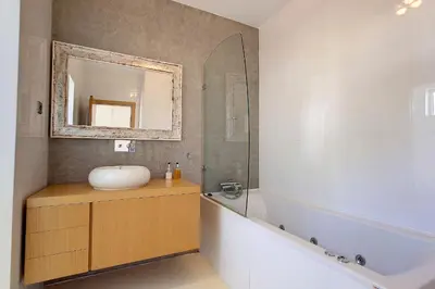 a bathroom with a sink and a mirror and a tub at Villa Ravenala - by LovelyStay in Funchal