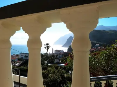 a view of the ocean from the balcony of a building at Vivenda Linda Vista in Porto da Cruz
