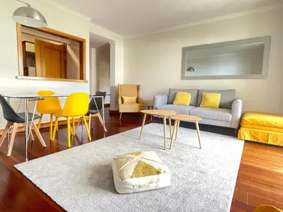 a living room with a couch and a table and chairs at Quinta Falesia Apartment in Funchal