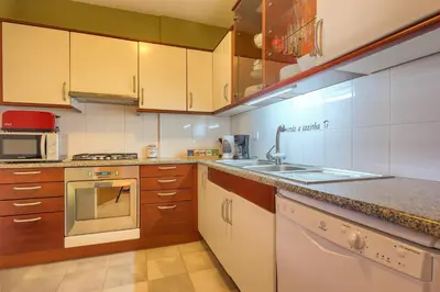 a kitchen with a sink and a stove at Quinta Falesia Apartment in Funchal