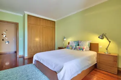 a bedroom with a large bed and a dresser at Quinta Falesia Apartment in Funchal