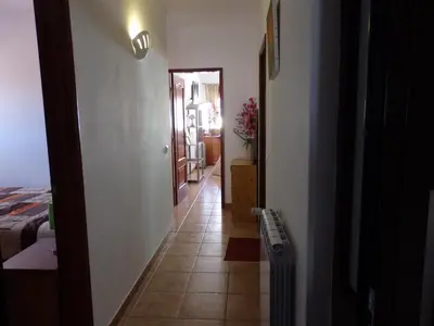 a hallway leading to a room with a bedroom and a mirror at Casa Riqueta Silva in Bordeira