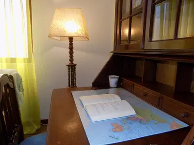 a table with a lamp and a book on a map at Pereira's house - Mountain & Sea in Porto da Cruz