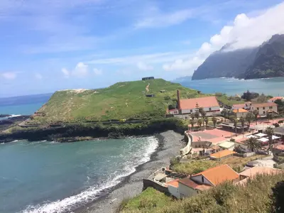 a small village on a hill next to the ocean at Pereira's house - Mountain & Sea in Porto da Cruz