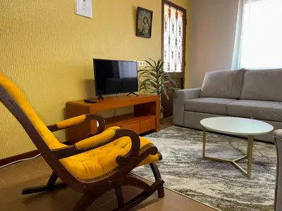 a living room with a couch and a chair at Pereira's house - Mountain & Sea in Porto da Cruz