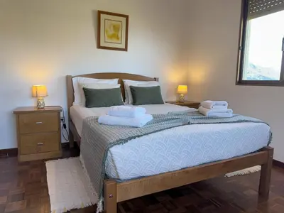 a bedroom with a bed with towels on it at Pereira's house - Mountain & Sea in Porto da Cruz