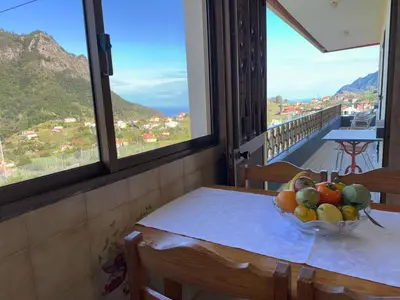 a bowl of fruit on a table in a room with windows at Pereira's house - Mountain & Sea in Porto da Cruz