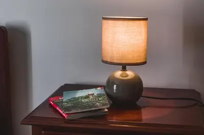 a lamp sitting on top of a table with a book at Funchal Downtown by ALMA Holiday Rentals in Funchal