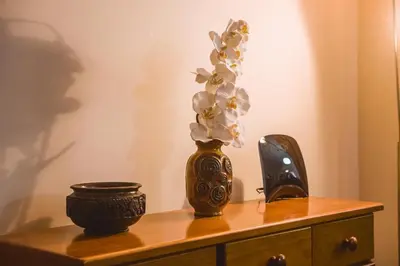 a vase with flowers in it on a table at Funchal Downtown by ALMA Holiday Rentals in Funchal