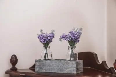 three vases filled with purple flowers on a table at Funchal Downtown by ALMA Holiday Rentals in Funchal
