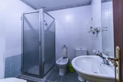 a bathroom with a shower and a toilet and a sink at Funchal Downtown by ALMA Holiday Rentals in Funchal