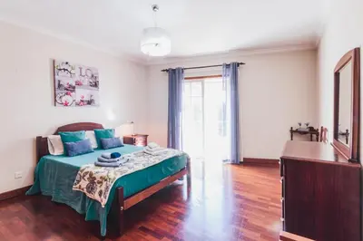 a bedroom with a bed with blue pillows on it at Funchal Downtown by ALMA Holiday Rentals in Funchal