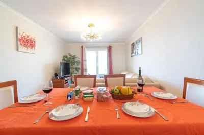 a dining room table with a orange table cloth at Apartamento Alberto in Funchal