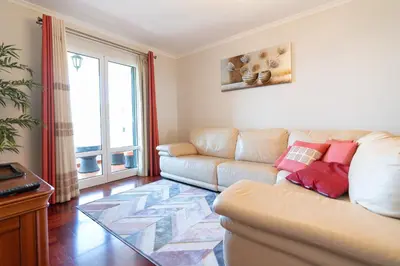 a living room with a couch and a large window at Apartamento Alberto in Funchal