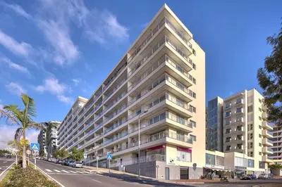 a tall building on the side of a street at Sunset Apartment by Holiday Rental Madeira in Funchal