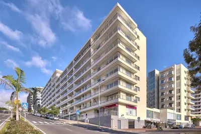 a tall building on the side of a street at Sunset Apartment by Holiday Rental Madeira in Funchal