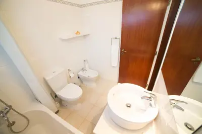 a bathroom with a sink and a toilet and a tub at FLH Praia da Luz House with Terrace in Luz