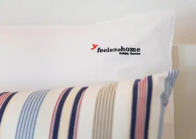 a white bag sitting on top of a bed at FLH Praia da Luz House with Terrace in Luz
