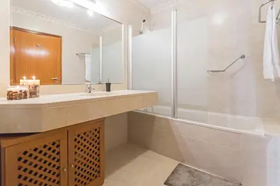 a bathroom with a tub and a sink and a shower at Ajuda II by An Island Apart in Funchal