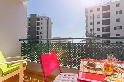 a balcony with a table and chairs on a balcony at Ajuda II by An Island Apart in Funchal