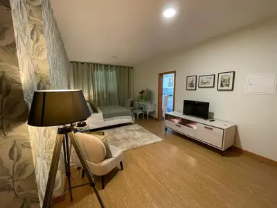 a living room with a bed and a television at Queimada Houses in Funchal