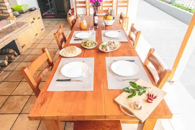 a wooden table with plates of food on it at Barreiros House in Funchal
