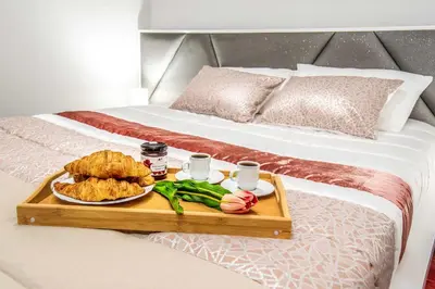 a tray with food and drinks on a bed at Barreiros House in Funchal