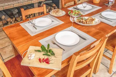 a wooden table with plates of food on it at Barreiros House in Funchal